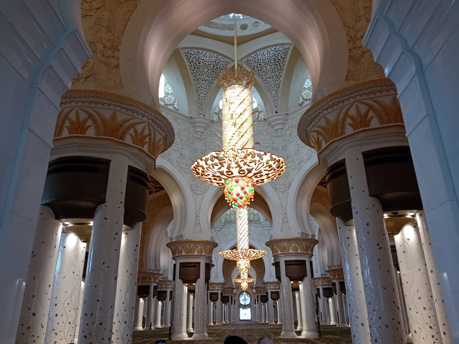 A glittering chandelier hanging inside the Sheikh Zayed Grand Mosque