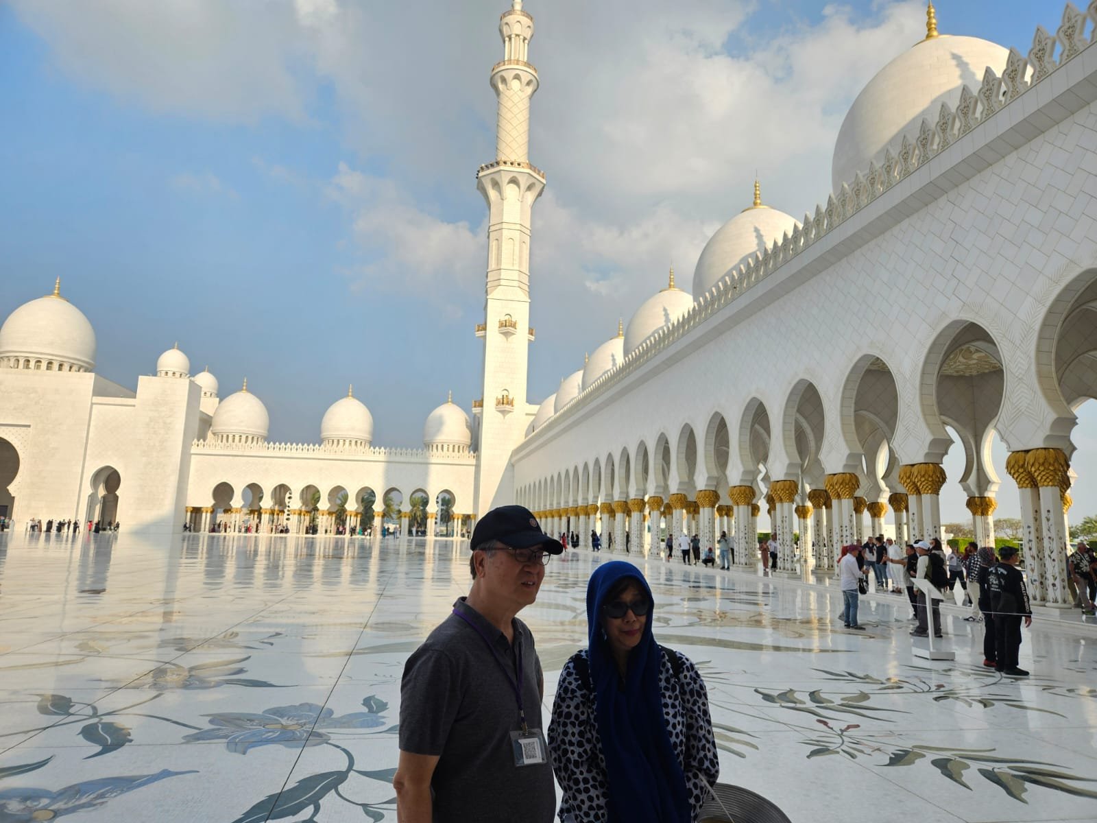 A couple taking a photo together inside the Sheikh Zayed Grand Mosque