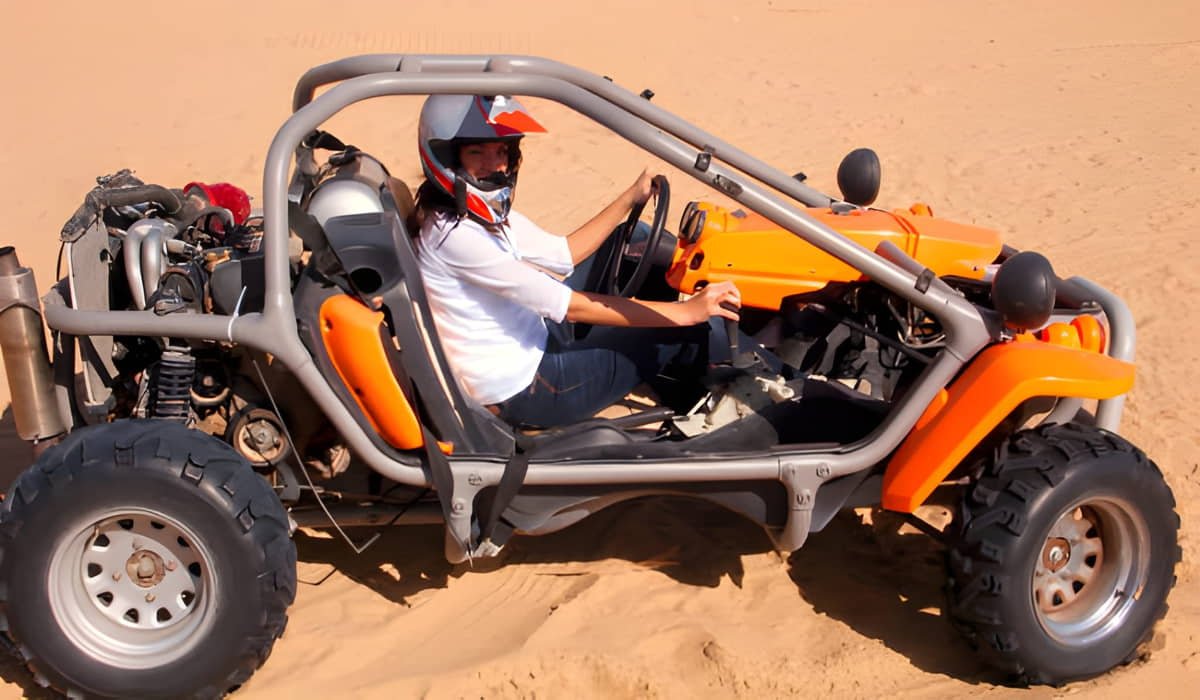 a man riding 2 seater quad bike